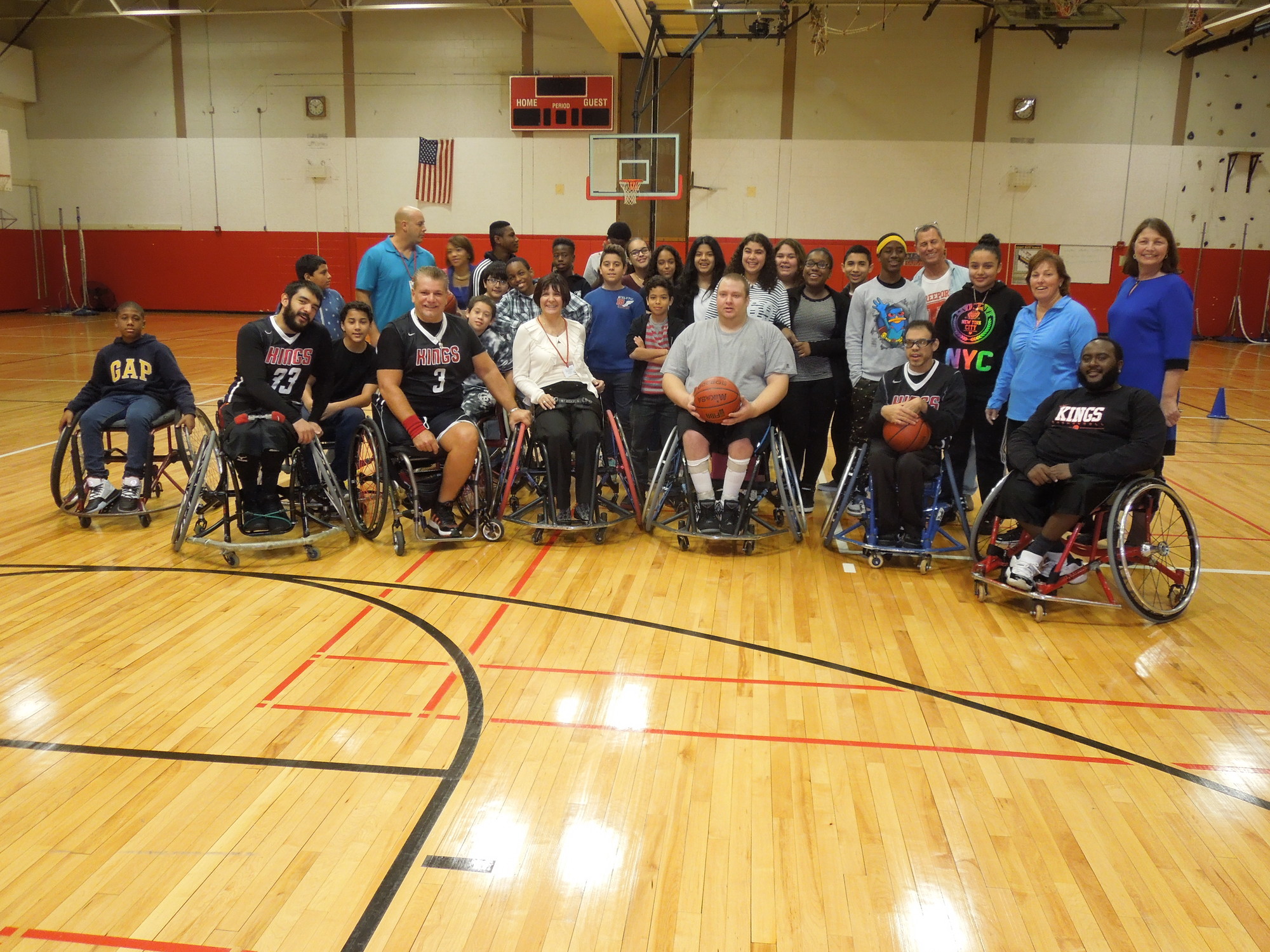 Members of the Kings Wheelchair Basektball team pose with Dodd students and administrators