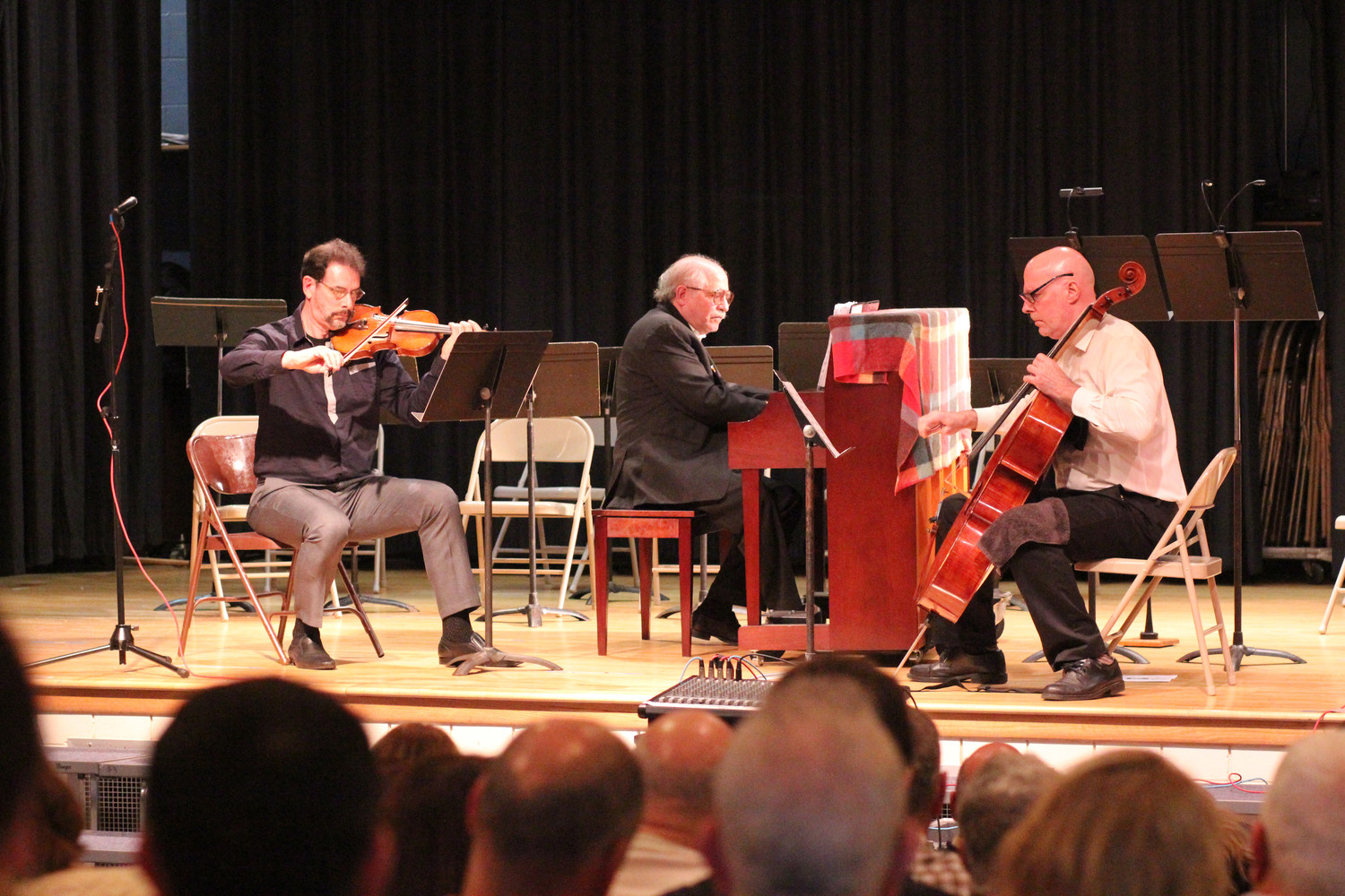 The Dakule Trio, from left, violinist Daniel Hyman, pianist Leonard Lehrman and cellist Kurt Behnke, performed “Trio (‘Invictus’),” a piece composed by Herbert Rothgarber in 2001, during a tribute to Rothgarber at Oceanside School No. 8 on Nov. 5.