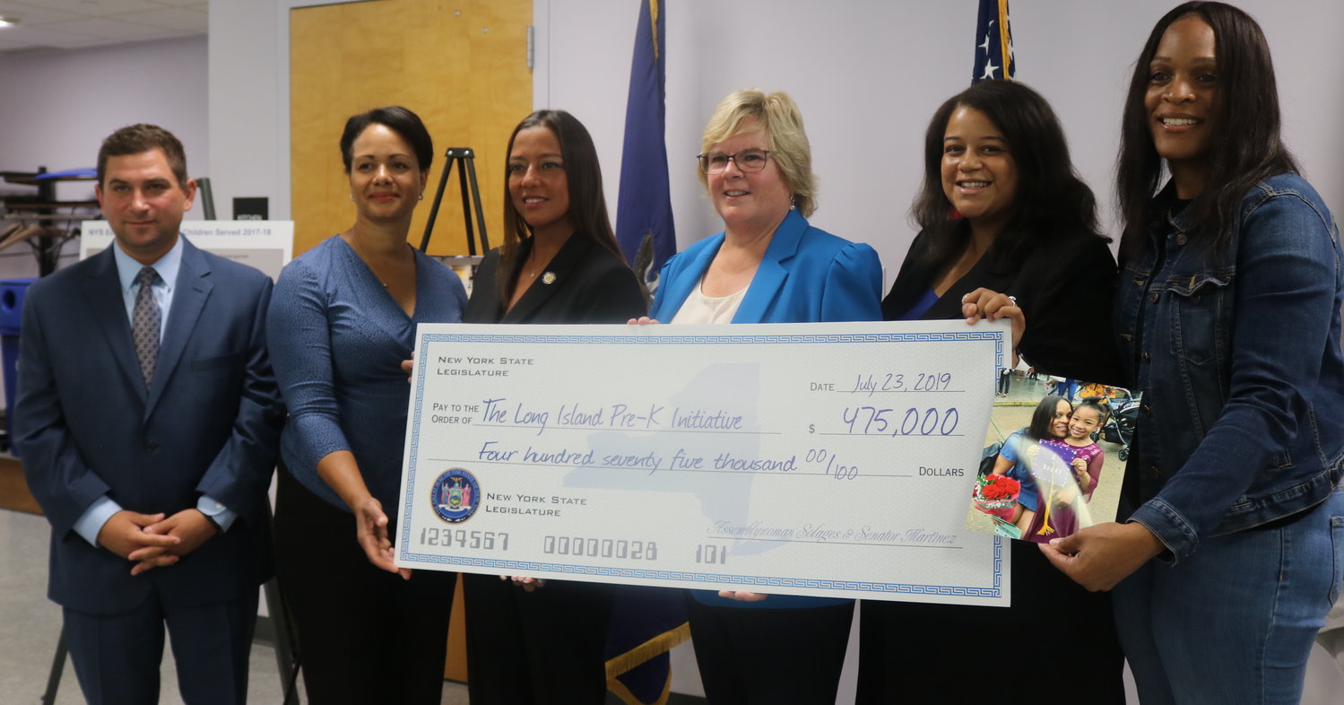 Matthew Cohen, vice president of government affairs for the Long Island Association, far left; Valley Stream District 13 Superintendent Constance Evelyn; State Sen. Monica Martinez; Pre-K Initiative Coordinator Lucinda Hurley; State Assemblywoman Michaelle Solages and Sara Morrison, who represented the Family Leadership Network, attended the check presentation on July 23. The group had helped secure $475,000 to explore ways to expand pre-kindergarten services on Long Island.