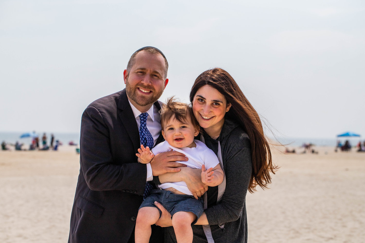 Rabbi Benny Berlin, his son Akiva, 1, and wife Sara.